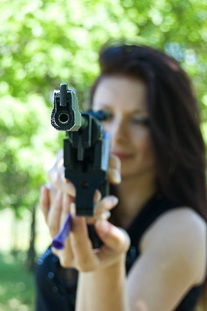 istock Woman aiming pneumatic gun 93262063