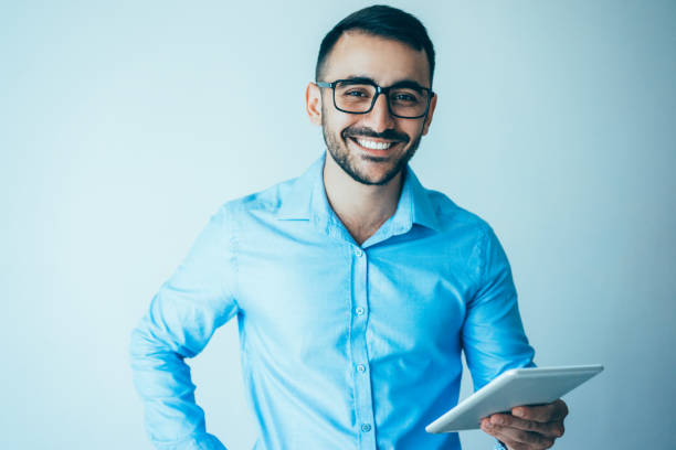 istock Happy Handsome Business Man Holding Tablet 932624428