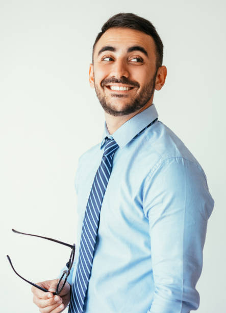 istock Relaxed Handsome Business Man Holding Glasses 932624508