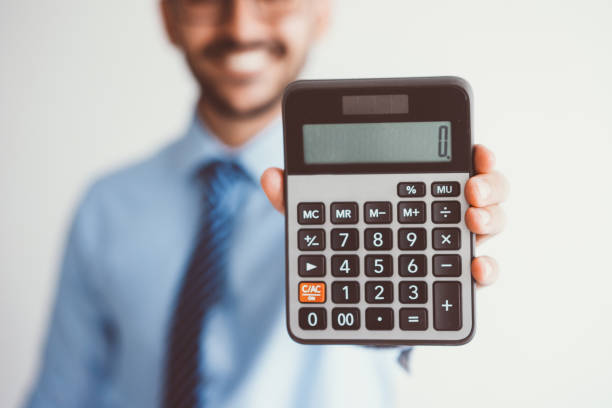Smiling Business Man Showing Zero on Calculator Closeup of blurred smiling young business man holding calculator and showing zero on it. Free of charge concept. Isolated front view on grey background. zero photos stock pictures, royalty-free photos & images