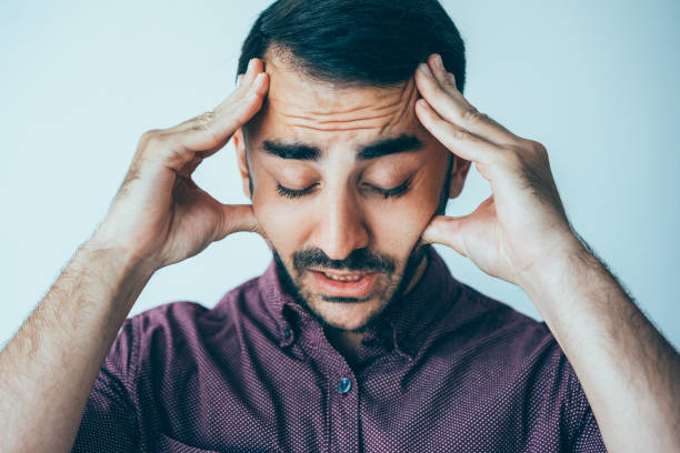 istock Tensed Man Touching Temples and Thinking Hard 932624550