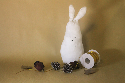 Vintage themed easter decoration with self made white easter bunny stuffed animal that is from recycled old shitr.\nMade by photographer and not store bought.