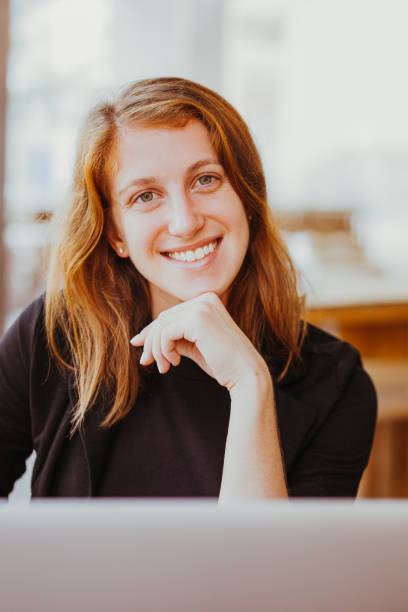 istock Joyful Woman at Cafe and Smiling Broadly at Camera 932627400