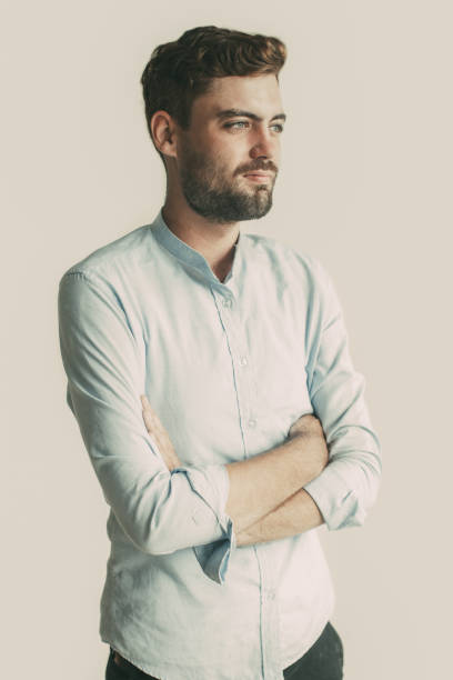 istock Portrait of Thoughtful Young Man Folding Arms 932632436