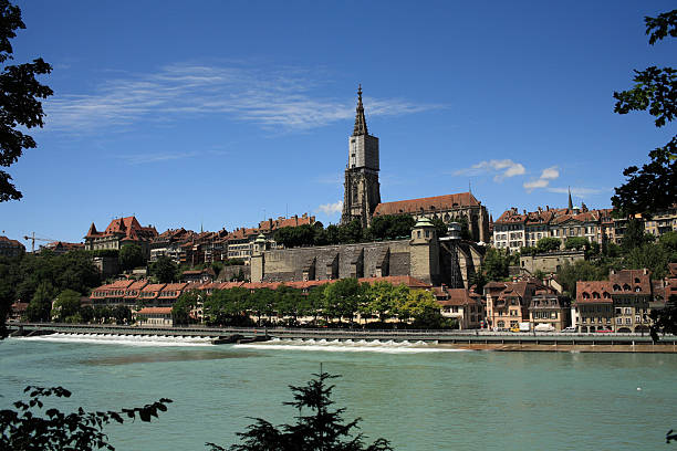 Bern Switzerland - April 16, 2018: The Cathedral Tower dominates other historic townhouses in the Old Town.
