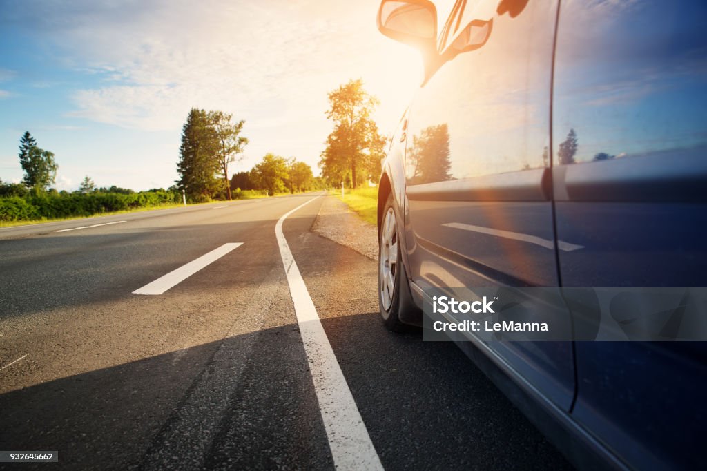 Car on asphalt road in summer Car on asphalt road on summer day at park. Automobile on highway Car Stock Photo