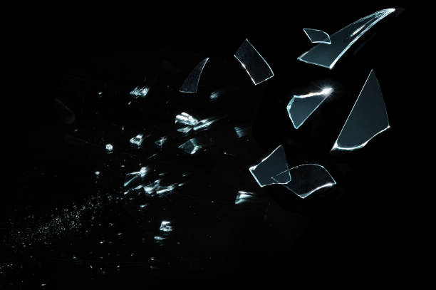 istock Shattered and split glass pieces isolated on black 932646202