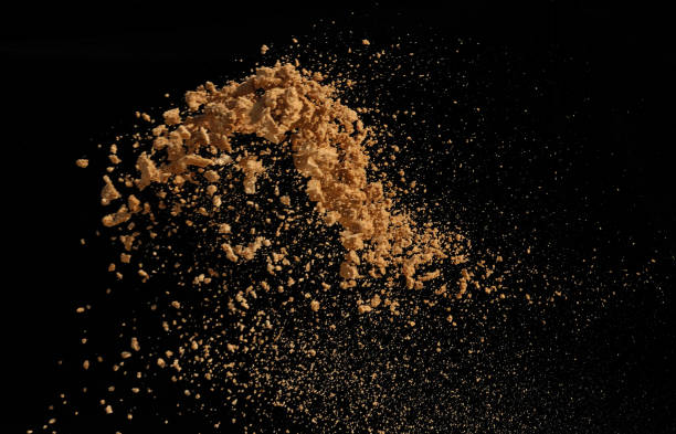 istock Pile of soil dropping isolated on black background 932646592