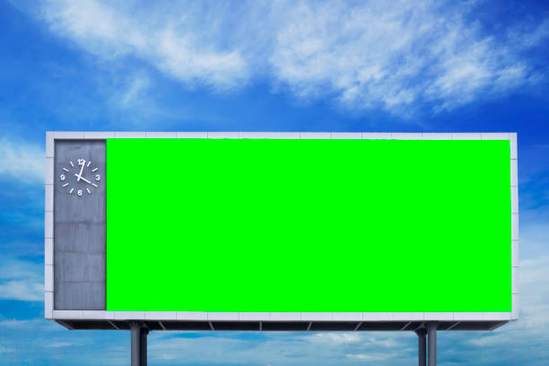 istock empty blank green screen billboard sign with blue sky at background 932650040