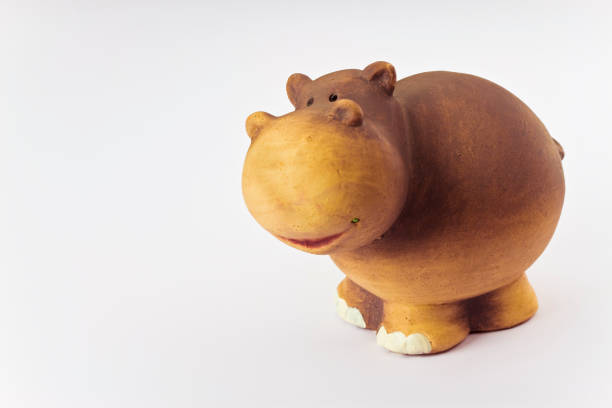 istock Ceramic hippopotamus toy isolated on white background - image with copy space 932651042