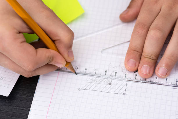 istock Mathematics Concept. Schoolboy Hands with Ruler Drawing on White Paper. 932651826
