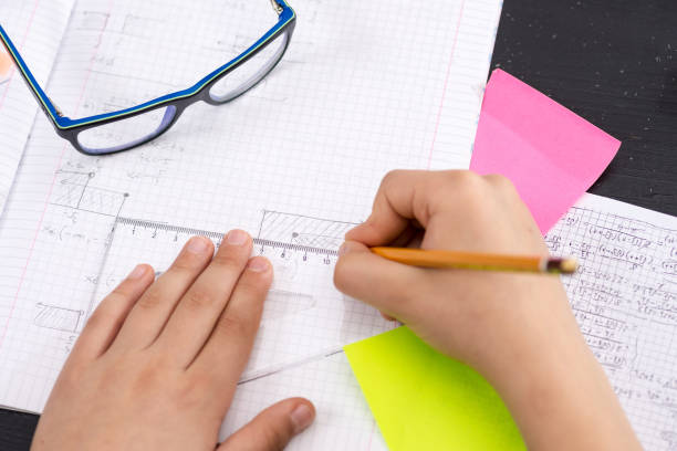 istock Mathematics Concept. Schoolboy Hands with Ruler Drawing on White Paper. 932653970