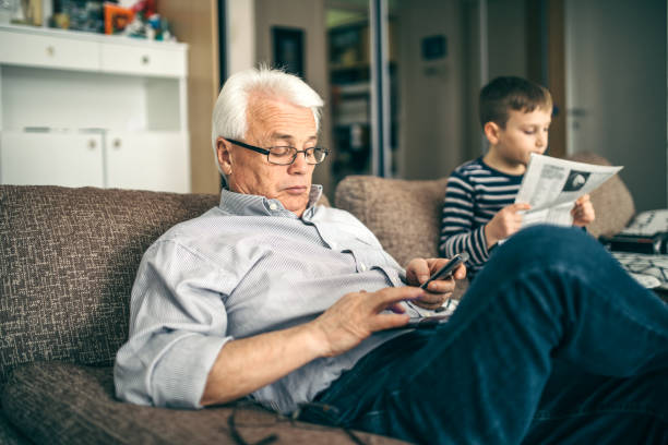 istock Grandfather is playing with cell phone 932654656