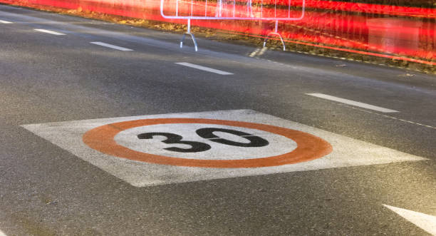 istock speed limit sign on a tarmac road by night 932654680