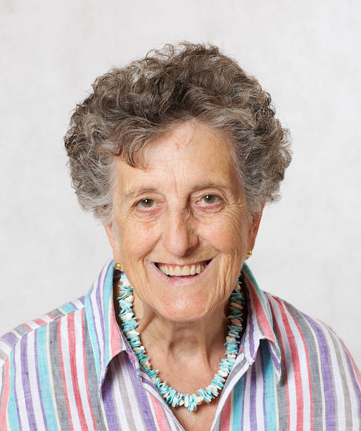istock Old smiling woman between 70 and 80 years old. Closeup 932654700