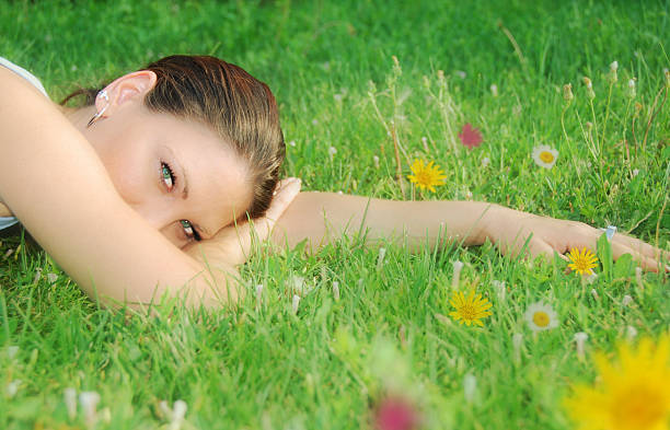 istock Beautiful young woman relaxing in the grass 93265515