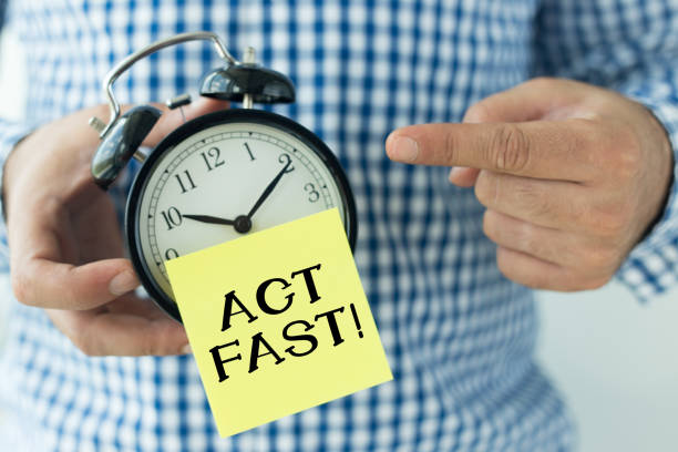 istock Hand Holding Alarm Clock and Pointing ACT FAST! 932655184