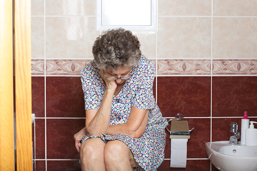 Senior woman between 70 and 80 years old in her bath room