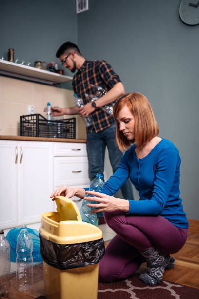 istock Reduce, Reuse and Recycle - ginger woman with plastic waste 932671514