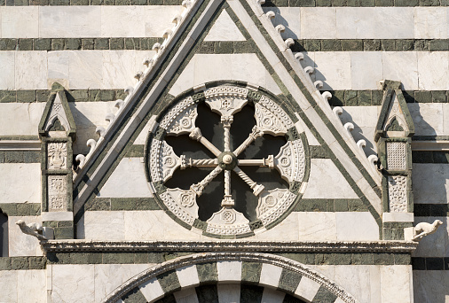 Detail of the Baptistery of San Giovanni in corte or Ritondo (1303-1361) in Cathedral square (Piazza Duomo). Pistoia, Tuscany, Italy