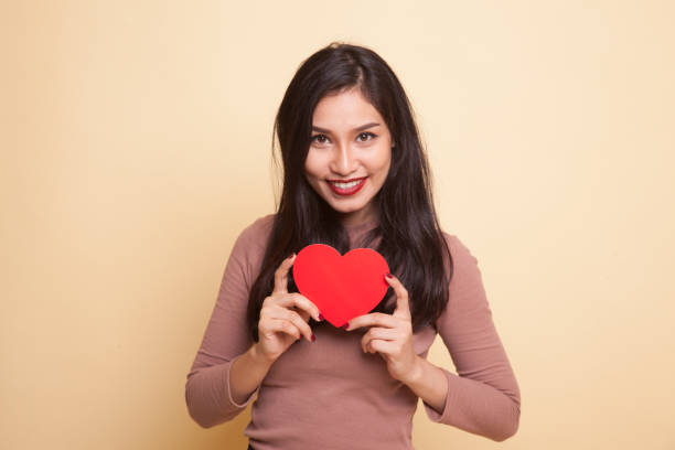 istock Asian woman with red heart. 932674568