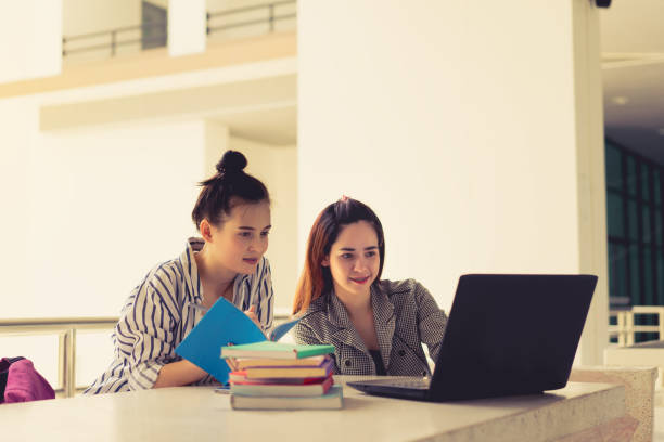istock Student women teamwork together working study online or homework with laptop computer and meeting in university campus indoor 932674972
