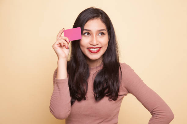 istock Young Asian woman think with a blank card. 932678536