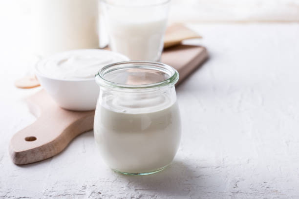 organic sour cream in glass jar Homemade organic sour cream in glass jar on rustic table yogurt stock pictures, royalty-free photos & images