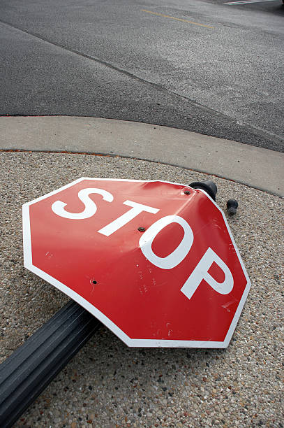Stop sign lying in the street as the result of an accident stock photo