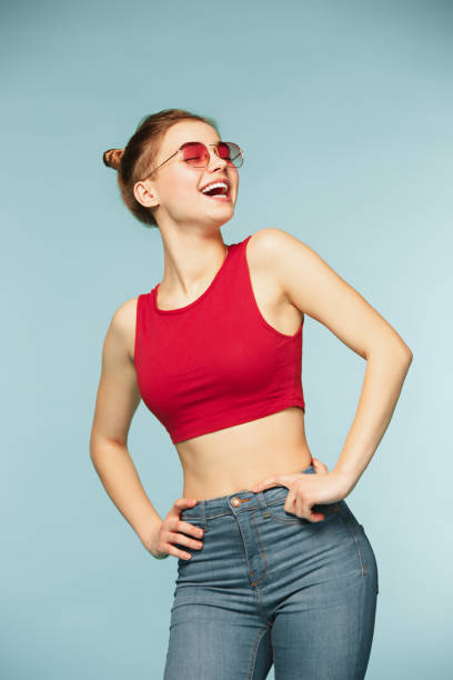 istock Woman smiling with perfect smile on the blue studio background 932717066