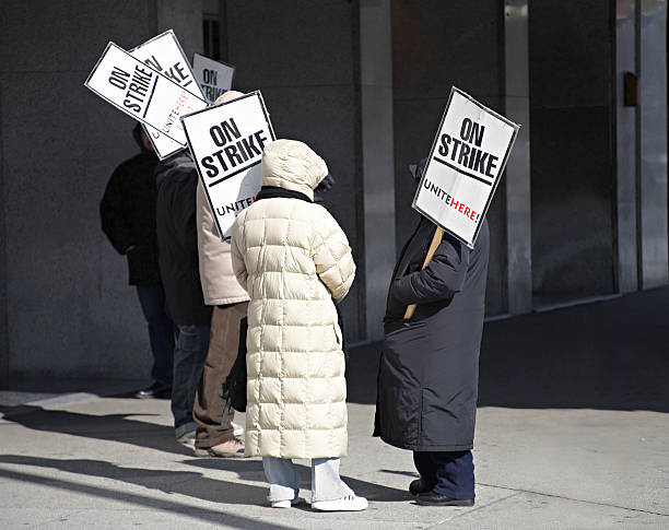 Labor Dispute Workers on strike outside a hotel imbalance photos stock pictures, royalty-free photos & images