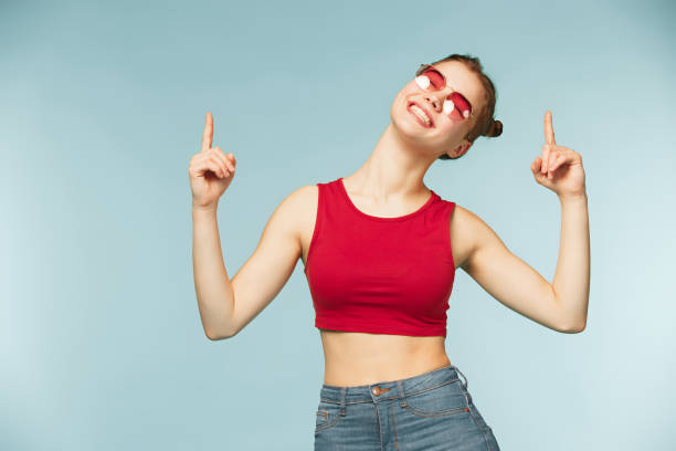 istock Woman smiling with perfect smile on the blue studio background 932717930