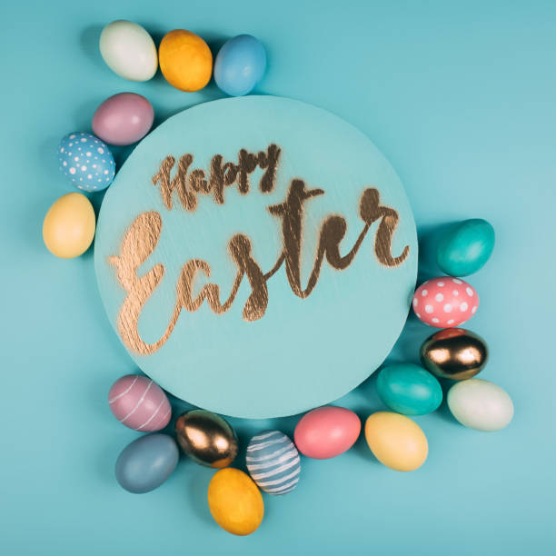 istock top view of round board with happy easter lettering and various colorful easter eggs on blue surface 932718048