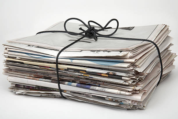 A picture of a bundle of newspapers Newspapers tied up with string and ready for recycling bundle stock pictures, royalty-free photos & images
