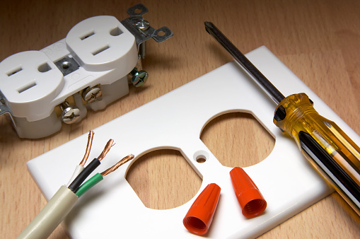 American electrical outlet and cover plate, with screwdriver and wire nuts