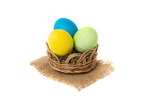 istock Easter eggs in a wicker basket isolated on white background 932724192