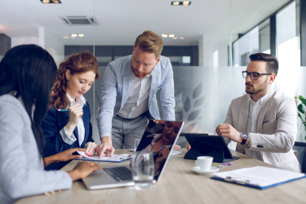 istock Businessman explaining business plan to coworkers 932724256