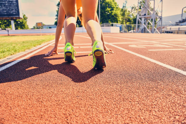 istock Blond sporty female runner to quick start position. 932724300