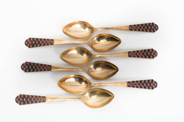 Vintage golden spoon on a white background