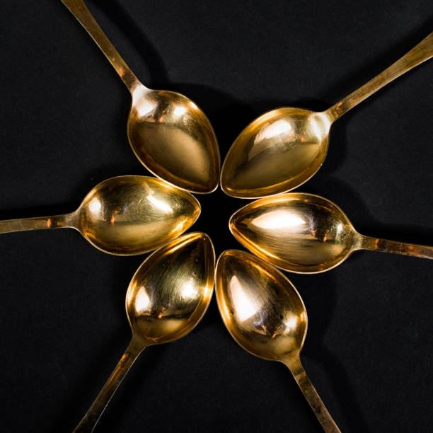 istock Vintage golden spoon on a gray background 932724742