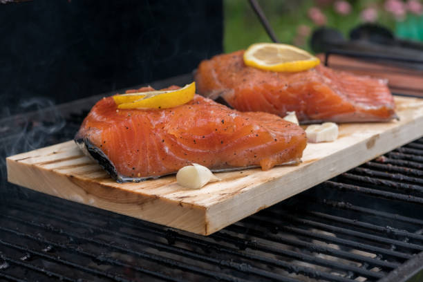 istock cedar plank salmon with lemon on a grill 932725650