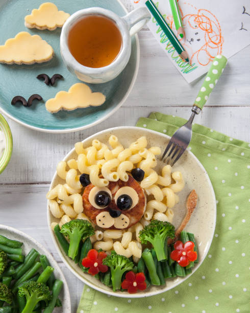 istock Funny Lion Food Face with Cutlet, Pasta and Vegetables 932728774