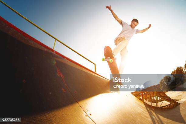 Teen Skater Hang Up Over A Ramp On A Skateboard In A Skate Park Stock Photo - Download Image Now