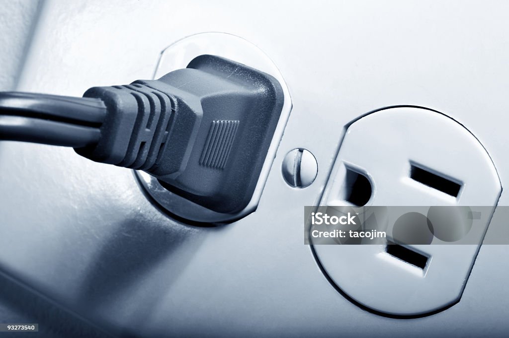 Electrical outlet with a black plug in one socket Electrical outlet Close-up Stock Photo