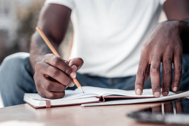 istock Close up of african american man taking notes 932736164