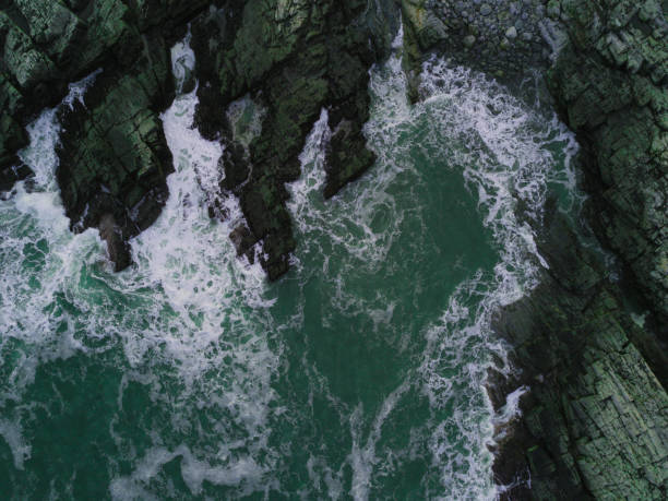 istock Aerial View of Waves Hitting Rocks 932742932