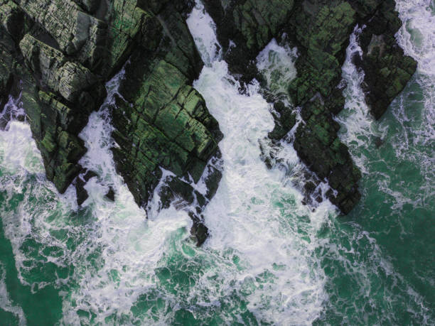 istock Aerial View of Waves Hitting Rocks 932742940