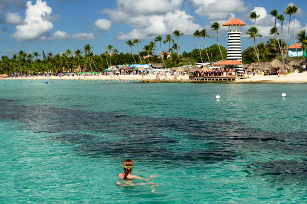 Relaxing tourist swimming on the Dominicus beach on Dominican Republic. Coast of the Del Este national park close the capital city Santo Domingo