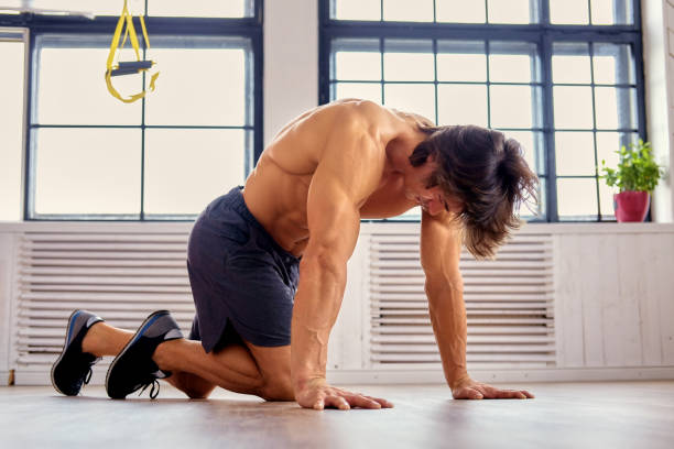 istock A man doing workouts on a floor in a room. 932743800