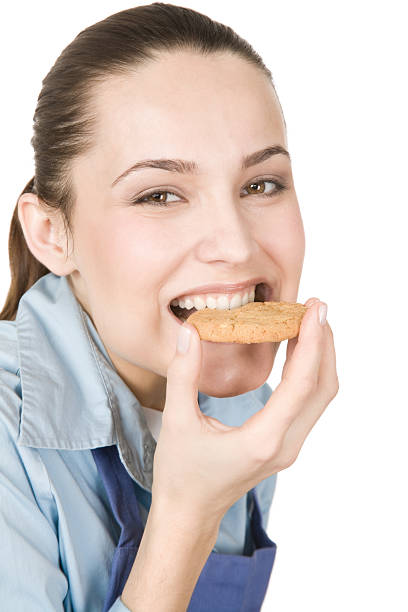 istock A woman taking a bite out of a cookie 93274559